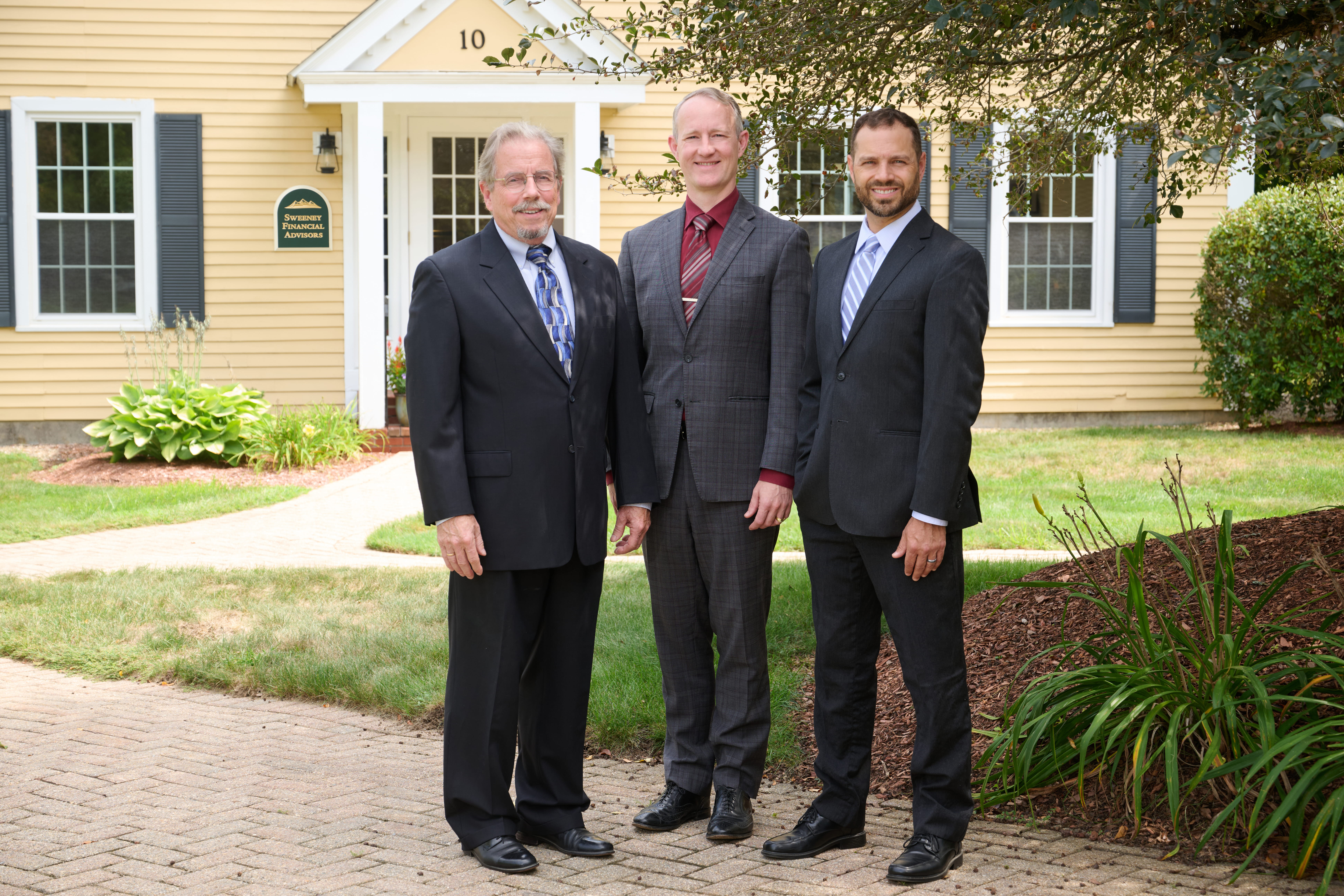 Glenn Sweeney, David Snyder and Christopher June outside the Sweeney Financial Advisors Bedford office