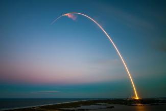rocket launch light trail at dusk by SpaceX courtesy of Unsplash.